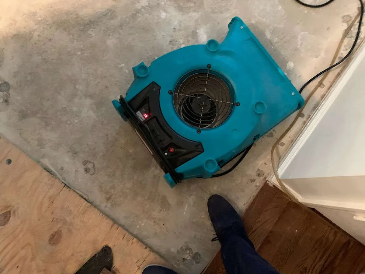 Air mover drying subfloor during Commercial Water Damage Restoration in Batavia